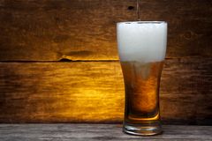 glass-beer-over-vintage-wood-background