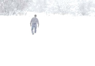 person walking through the snow