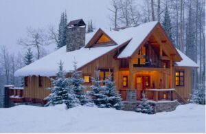 log home with snow on the roof
