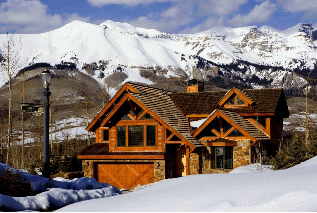 Log home with snow capped 