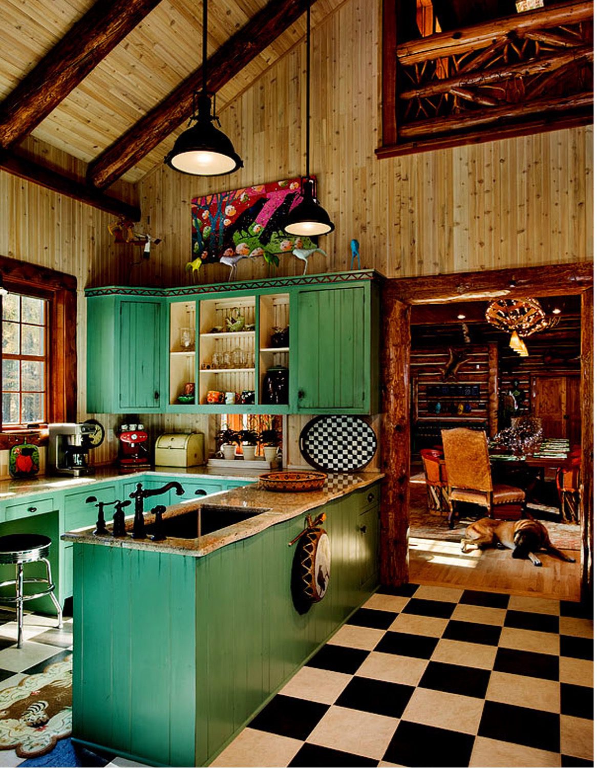 Kitchen in a log home with a dog on the tile floor